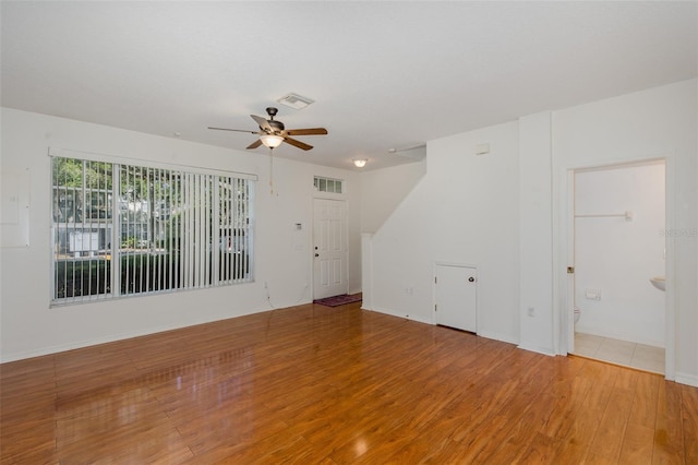 13521 Forest Lake Dr, Largo, FL 33771 - empty room featuring light wood-style flooring, a ceiling fan, and baseboards