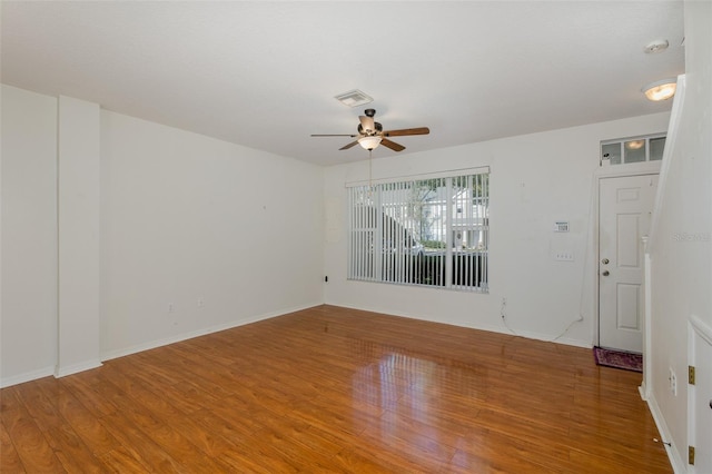 13521 Forest Lake Dr, Largo, FL 33771 - spare room with a ceiling fan, wood finished floors, and baseboards