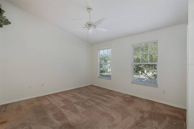 13521 Forest Lake Dr, Largo, FL 33771 - carpeted spare room with lofted ceiling, a ceiling fan, and baseboards