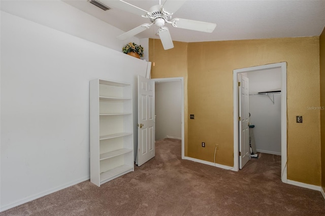 13521 Forest Lake Dr, Largo, FL 33771 - unfurnished bedroom featuring carpet flooring, a walk in closet, a closet, and baseboards