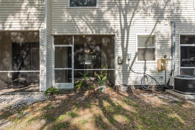 13521 Forest Lake Dr, Largo, FL 33771 - rear view of house featuring central air condition unit and a sunroom