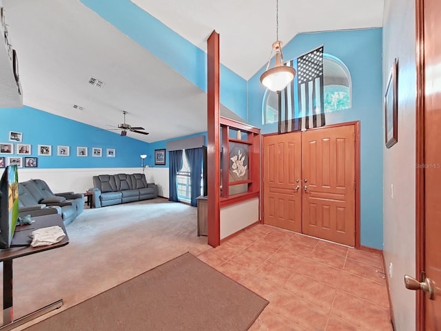 13094 Huntington Woods Ave, Spring Hill, FL 34609 - entrance foyer with light tile patterned floors, ceiling fan, light colored carpet, and high vaulted ceiling
