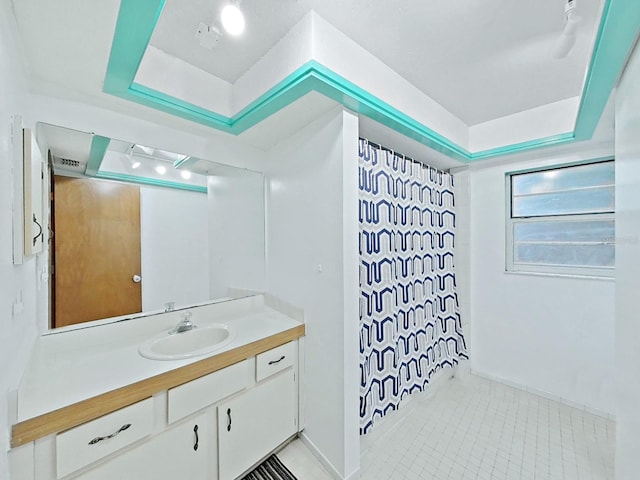 13094 Huntington Woods Ave, Spring Hill, FL 34609 - full bathroom featuring vanity, a raised ceiling, curtained shower, and tile patterned floors