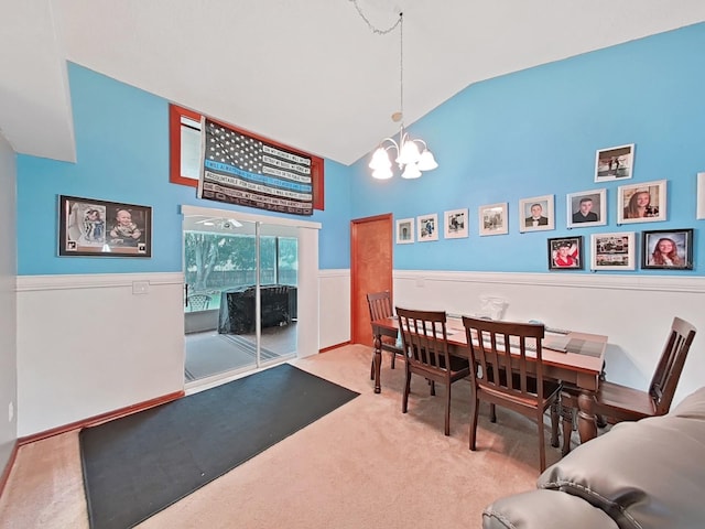 13094 Huntington Woods Ave, Spring Hill, FL 34609 - carpeted dining area featuring a chandelier, high vaulted ceiling, and a wainscoted wall