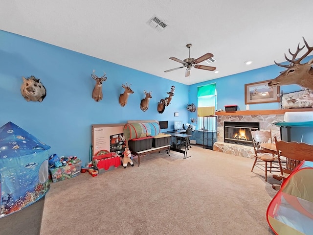 13094 Huntington Woods Ave, Spring Hill, FL 34609 - rec room featuring carpet, a stone fireplace, and ceiling fan