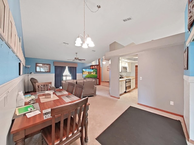 13094 Huntington Woods Ave, Spring Hill, FL 34609 - dining area with a chandelier, vaulted ceiling, light carpet, and a ceiling fan