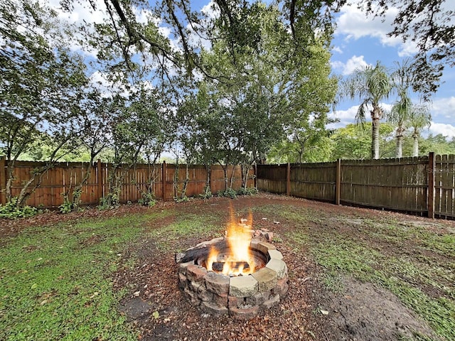 13094 Huntington Woods Ave, Spring Hill, FL 34609 - fenced backyard with an outdoor fire pit