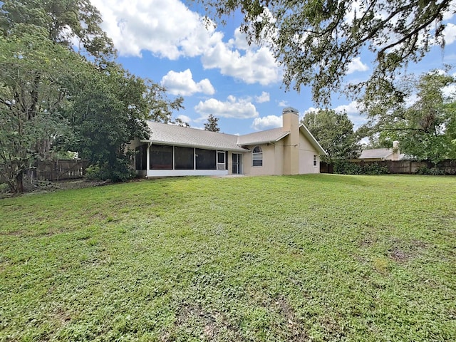 13094 Huntington Woods Ave, Spring Hill, FL 34609 - rear view of house with a chimney and a sunroom