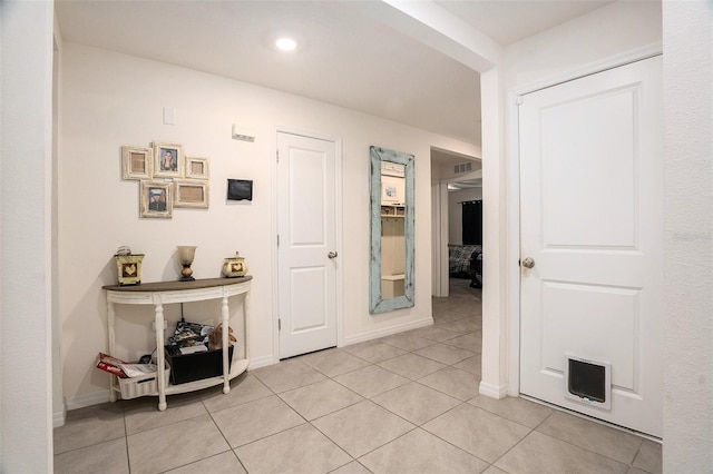 7639 Broad Pointe Dr, Zephyrhills, FL 33540 - hallway with light tile patterned flooring and baseboards
