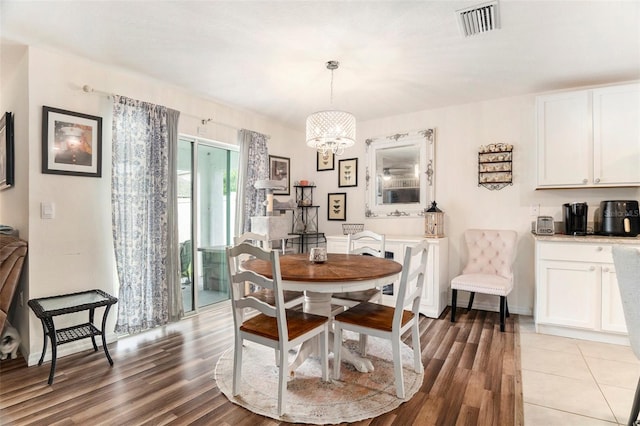 7639 Broad Pointe Dr, Zephyrhills, FL 33540 - dining room with light wood-style floors and a chandelier