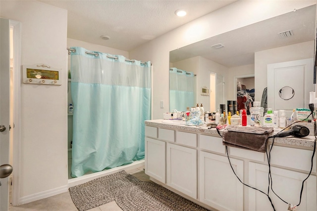 7639 Broad Pointe Dr, Zephyrhills, FL 33540 - bathroom featuring curtained shower, vanity, a spacious closet, and tile patterned floors