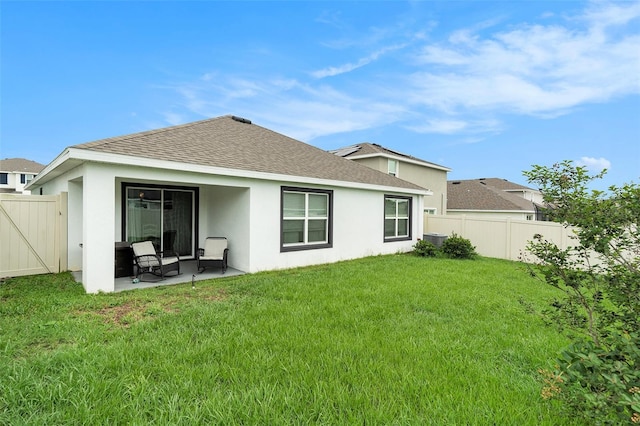 7639 Broad Pointe Dr, Zephyrhills, FL 33540 - rear view of house with roof with shingles, stucco siding, a fenced backyard, and a patio
