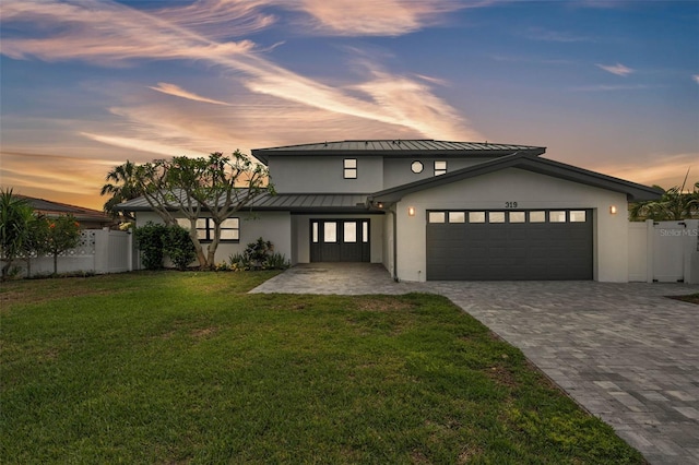 319 Midway Is, Clearwater Beach, FL 33767 - view of front facade with a standing seam roof, stucco siding, a garage, metal roof, and decorative driveway