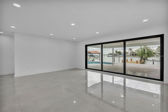 319 Midway Is, Clearwater Beach, FL 33767 - spare room with plenty of natural light, recessed lighting, and baseboards