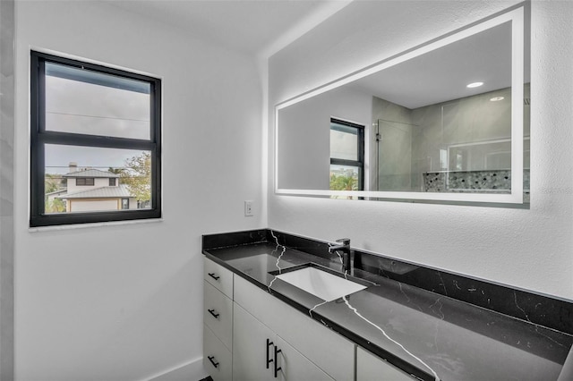 319 Midway Is, Clearwater Beach, FL 33767 - bathroom featuring vanity, tiled shower, plenty of natural light, and baseboards