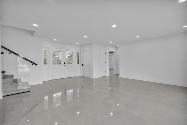 319 Midway Is, Clearwater Beach, FL 33767 - unfurnished living room with baseboards, tile patterned flooring, and recessed lighting