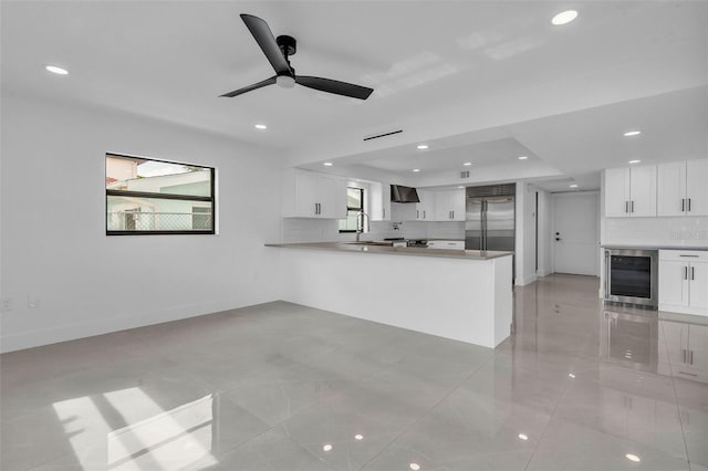 319 Midway Is, Clearwater Beach, FL 33767 - kitchen featuring wine cooler, built in refrigerator, wall chimney exhaust hood, decorative backsplash, and a sink
