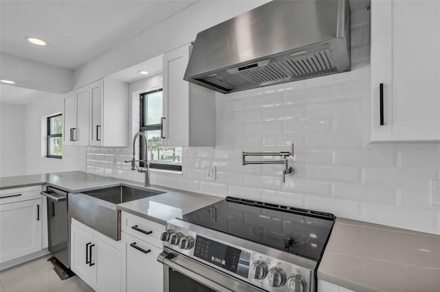 319 Midway Is, Clearwater Beach, FL 33767 - kitchen featuring extractor fan, appliances with stainless steel finishes, a sink, white cabinets, and recessed lighting