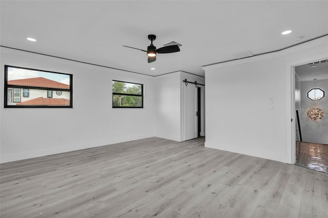 319 Midway Is, Clearwater Beach, FL 33767 - unfurnished room with light wood-style floors, a barn door, a ceiling fan, baseboards, and recessed lighting