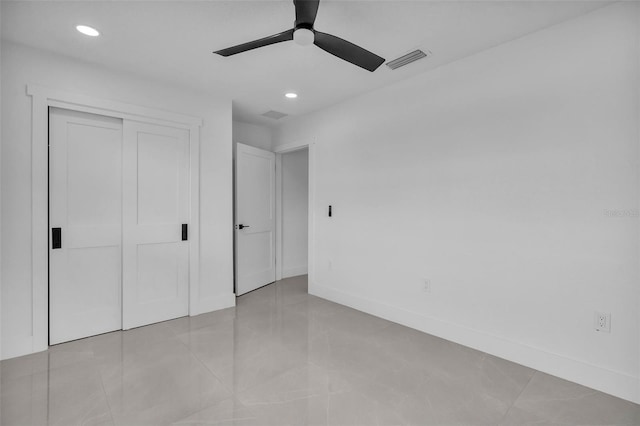 319 Midway Is, Clearwater Beach, FL 33767 - unfurnished bedroom with recessed lighting, a closet, a ceiling fan, baseboards, and light tile patterned flooring