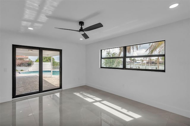 319 Midway Is, Clearwater Beach, FL 33767 - spare room featuring healthy amount of natural light, baseboards, ceiling fan, recessed lighting, and light tile patterned floors