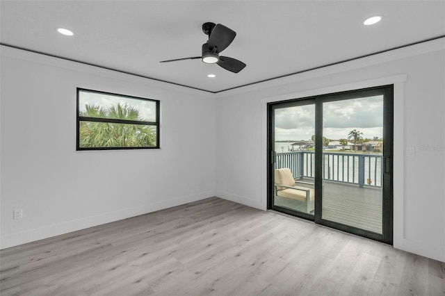 319 Midway Is, Clearwater Beach, FL 33767 - empty room with healthy amount of natural light, wood finished floors, recessed lighting, and crown molding