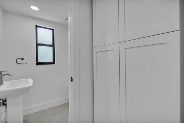 319 Midway Is, Clearwater Beach, FL 33767 - bathroom with baseboards, a sink, tile patterned floors, and recessed lighting