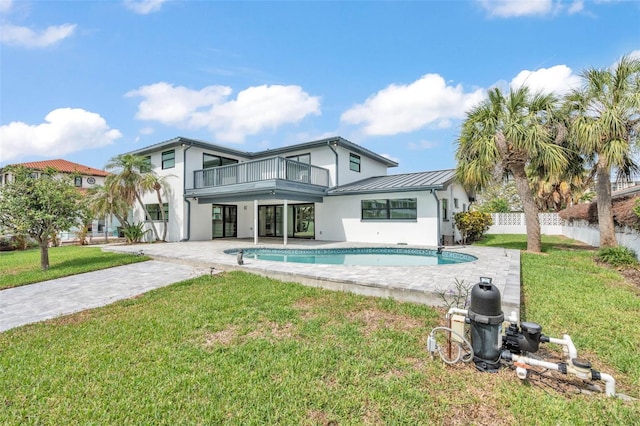 319 Midway Is, Clearwater Beach, FL 33767 - rear view of house with a balcony, stucco siding, an outdoor pool, a standing seam roof, and a patio area