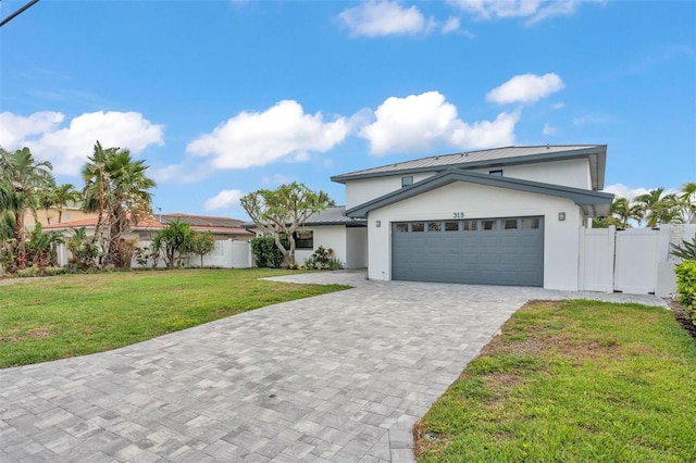 319 Midway Is, Clearwater Beach, FL 33767 - view of front facade with stucco siding, metal roof, an attached garage, decorative driveway, and a standing seam roof