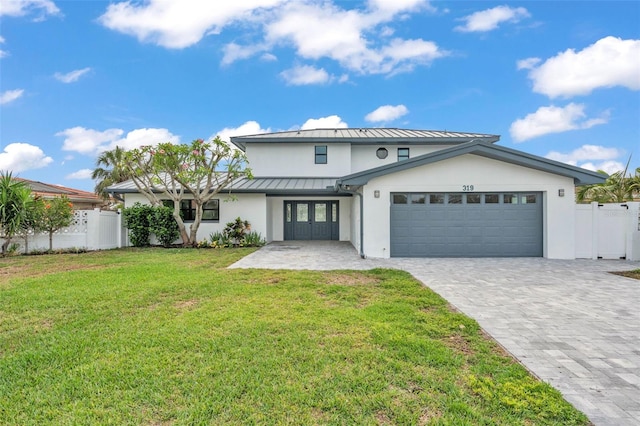 319 Midway Is, Clearwater Beach, FL 33767 - view of front facade with a standing seam roof, stucco siding, french doors, an attached garage, and decorative driveway