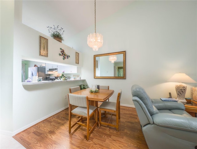 39650 US Highway 19 N, Tarpon Springs, FL 34689 - dining space with a chandelier, baseboards, wood finished floors, and high vaulted ceiling