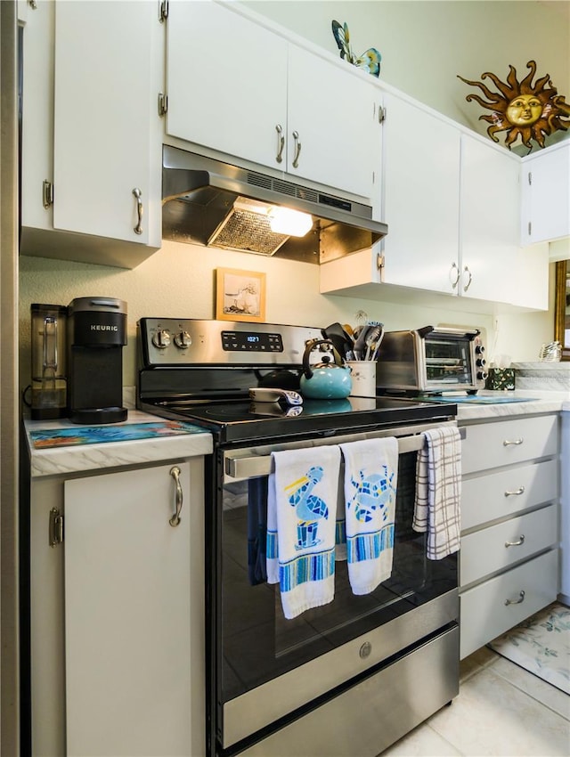 39650 US Highway 19 N, Tarpon Springs, FL 34689 - kitchen with stainless steel electric range, under cabinet range hood, light countertops, and white cabinets