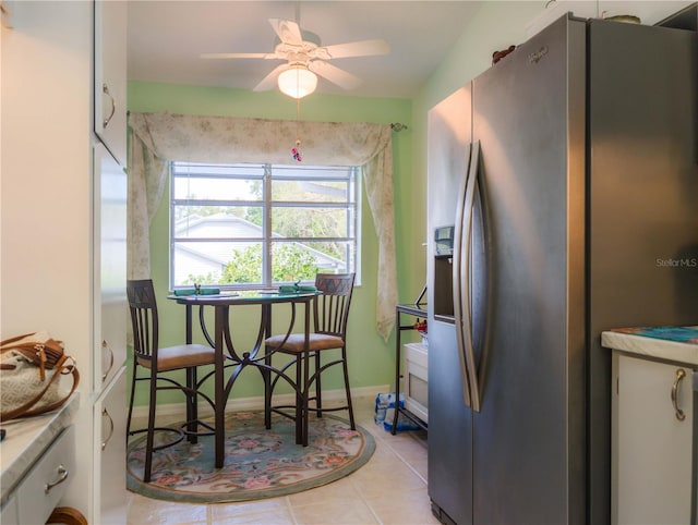 39650 US Highway 19 N, Tarpon Springs, FL 34689 - dining space with light tile patterned floors, ceiling fan, and baseboards