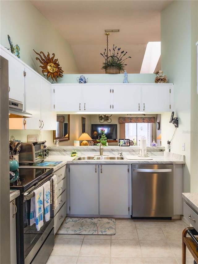 39650 US Highway 19 N, Tarpon Springs, FL 34689 - kitchen with appliances with stainless steel finishes, exhaust hood, light tile patterned flooring, a sink, and high vaulted ceiling