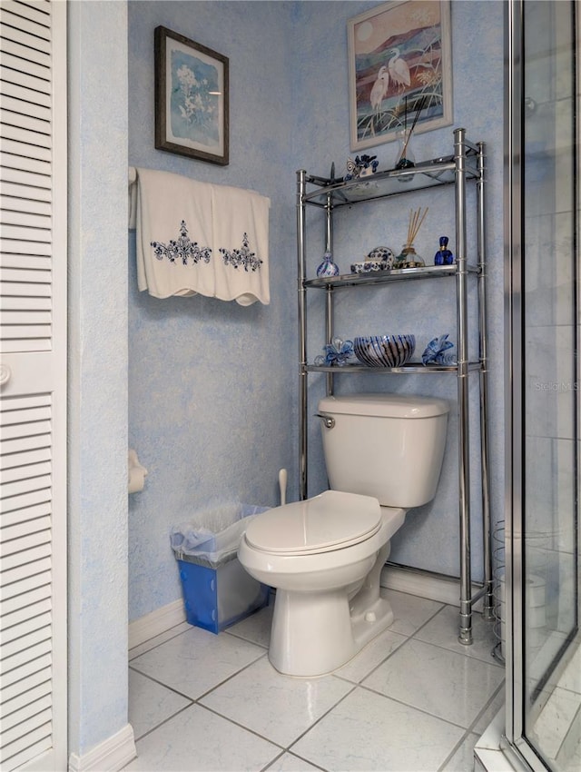 39650 US Highway 19 N, Tarpon Springs, FL 34689 - full bathroom featuring toilet, baseboards, tile patterned floors, a stall shower, and a closet