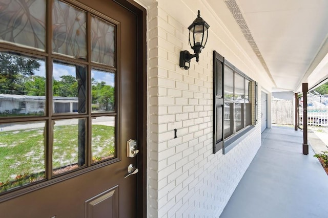 229 Temple Ave, Fern Park, FL 32730 - doorway to property with a porch and brick siding