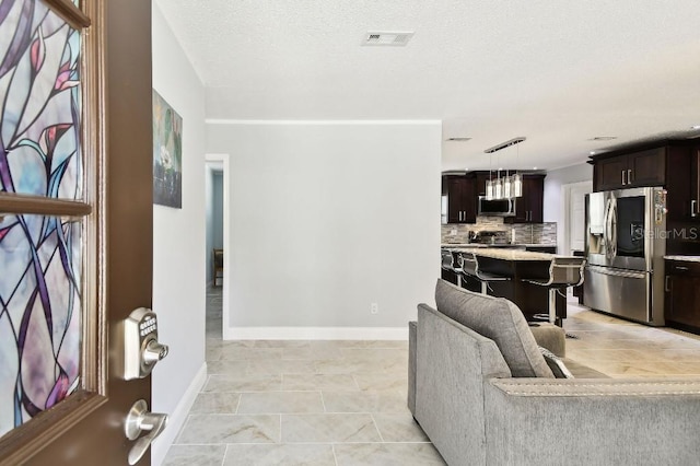 229 Temple Ave, Fern Park, FL 32730 - living room featuring baseboards, light tile patterned floors, and a textured ceiling
