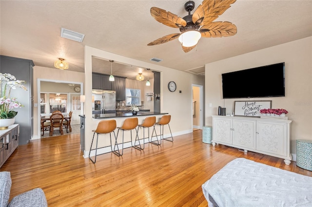 2709 Upton St S, Gulfport, FL 33711 - living area with light wood-style flooring and a ceiling fan