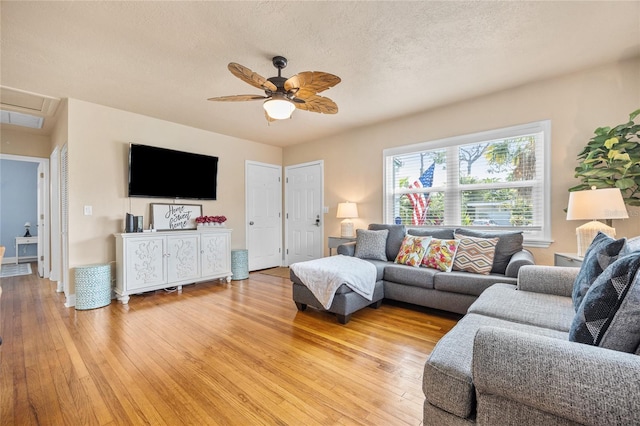 2709 Upton St S, Gulfport, FL 33711 - living room featuring light wood-style floors, ceiling fan, and a textured ceiling