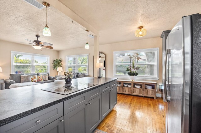 2709 Upton St S, Gulfport, FL 33711 - kitchen with freestanding refrigerator, dark countertops, a textured ceiling, open floor plan, and gray cabinetry