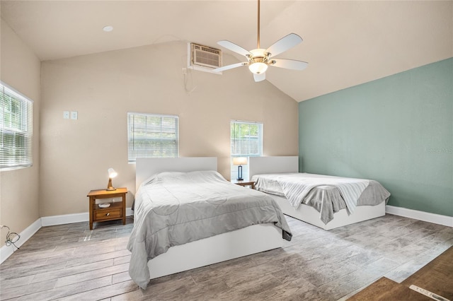 2709 Upton St S, Gulfport, FL 33711 - bedroom with multiple windows, a wall mounted AC, wood finished floors, baseboards, and high vaulted ceiling