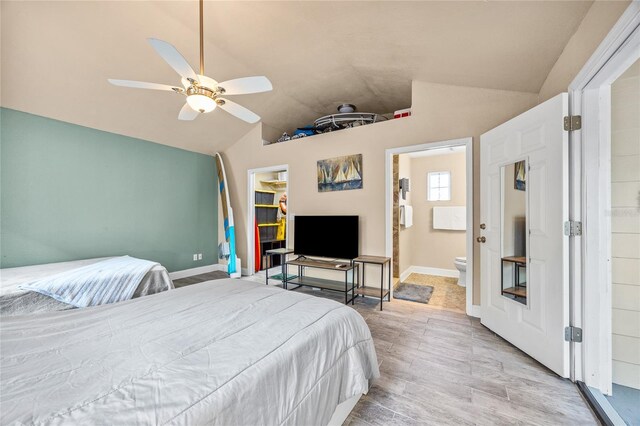 2709 Upton St S, Gulfport, FL 33711 - bedroom featuring lofted ceiling, wood finished floors, baseboards, a spacious closet, and ensuite bath