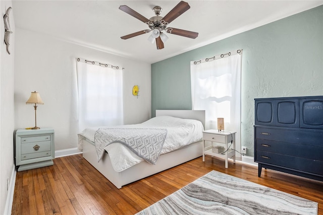 2709 Upton St S, Gulfport, FL 33711 - bedroom featuring multiple windows, wood-type flooring, a ceiling fan, and baseboards