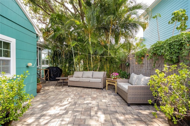 2709 Upton St S, Gulfport, FL 33711 - fenced backyard featuring an outdoor living space, a patio area, and grilling area