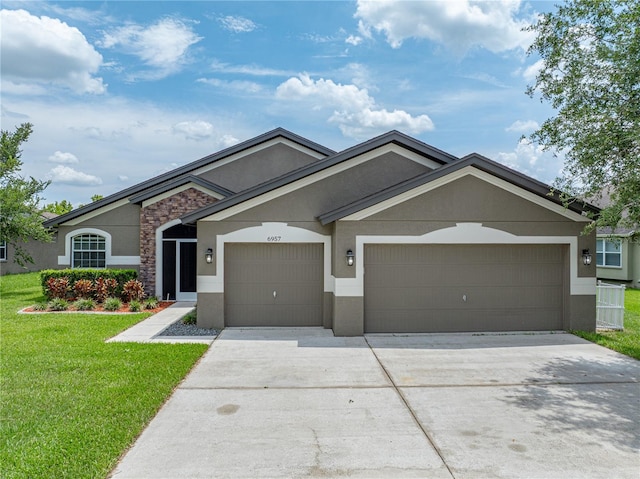 6957 Boulder Run Loop, Wesley Chapel, FL 33545 - ranch-style house with stucco siding, a front yard, an attached garage, driveway, and stone siding