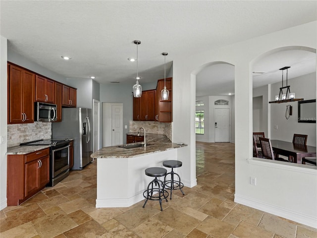 6957 Boulder Run Loop, Wesley Chapel, FL 33545 - kitchen featuring stainless steel appliances, open shelves, decorative backsplash, a kitchen breakfast bar, and recessed lighting