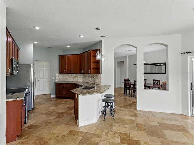 6957 Boulder Run Loop, Wesley Chapel, FL 33545 - kitchen featuring stainless steel microwave, a sink, stone tile flooring, open shelves, and tasteful backsplash