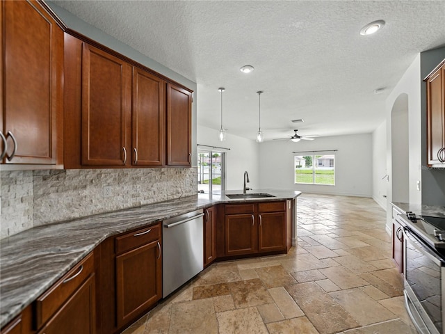 6957 Boulder Run Loop, Wesley Chapel, FL 33545 - kitchen featuring stainless steel appliances, a sink, ceiling fan, decorative backsplash, and stone tile floors