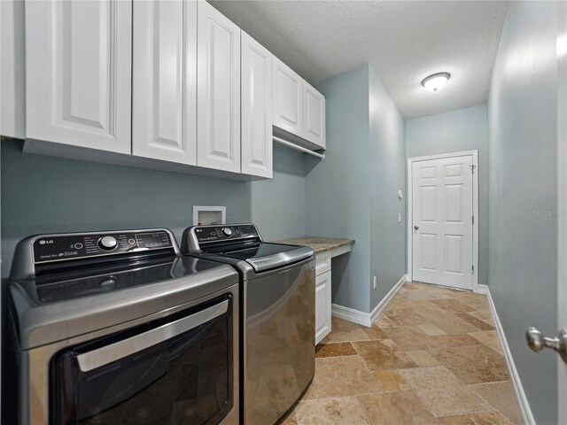 6957 Boulder Run Loop, Wesley Chapel, FL 33545 - laundry room with cabinet space, stone tile floors, baseboards, independent washer and dryer, and a textured ceiling