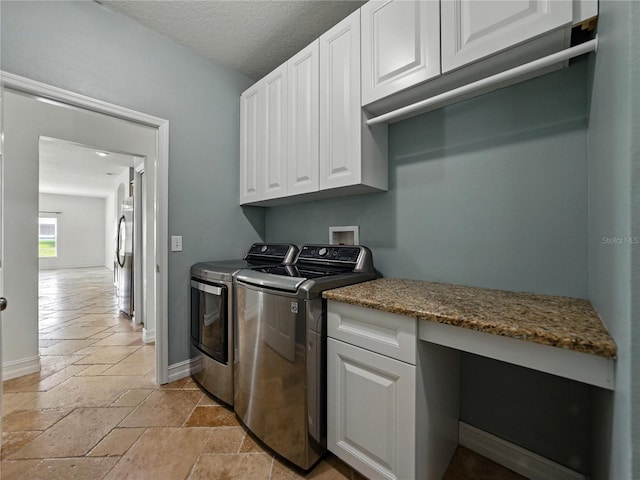 6957 Boulder Run Loop, Wesley Chapel, FL 33545 - laundry area with cabinet space, stone tile flooring, separate washer and dryer, baseboards, and a textured ceiling